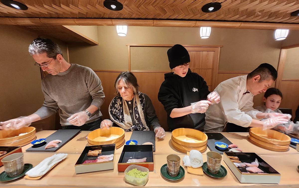 A family enjoying the experience of making their own sushi